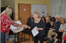 Kobieta w charakterystycznej bluzce gratulujaca kobiecie